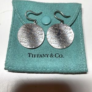 An authentic pair of Tiffany & Co. Silver name wavy dangle earrings